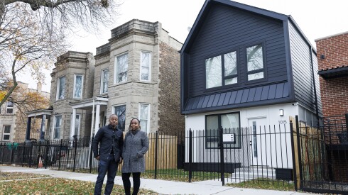 Bill Williams, founder and principal at KMW Communities, and Lynnette McRae, program director for Connecting Capital and Community, stand outside a recently built home in Humboldt Park. The executives are part of a group helping to build new homes and provide resources that help first time homebuyers on the West Side.