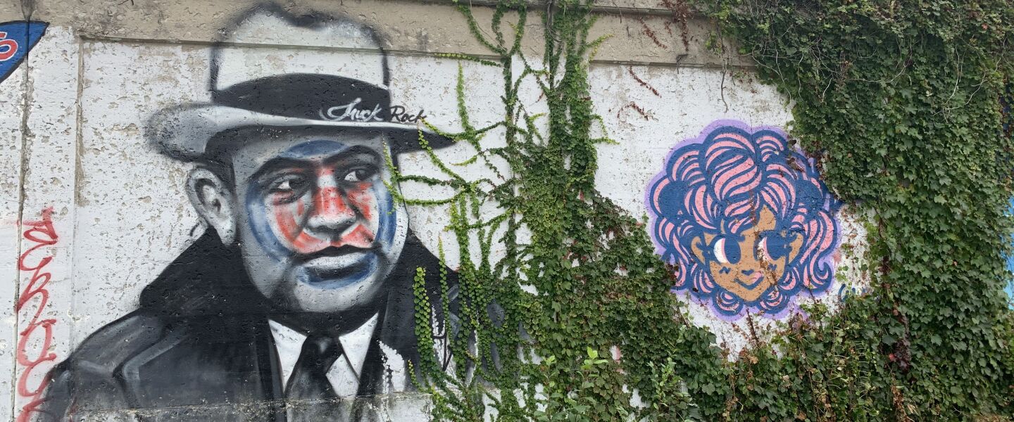 This mural of Chicago mob boss Al Capone was done by California artist Jules Muck, who goes by Muck Rock. Capone “is definitely a person of interest that I associate with Chicago,” says Muck, who painted a Cubs “tattoo” on his face. The woman’s face painted to Capone’s right was done by the 33-year-old artist who goes by Binx, who recently moved from Chicago to California. She says it’s “kind of a representation of myself.”