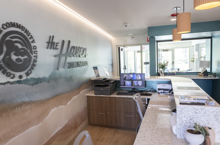 Front desk area with a sign saying The Haven on Lincoln against the wall.