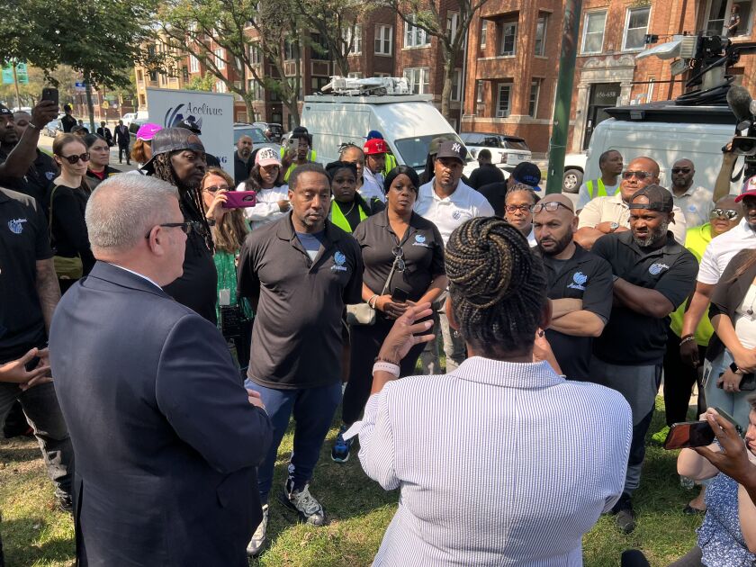 Republican governor candidate Darren Bailey and running mate Stephanie Trussell speak to Washington Park residents and activists Wednesday.