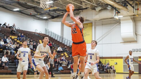 Naperville North's Will Harvey (22) goes to the basket asked against Geneva during the Hinkle Holiday Classic semis at Jacobs.
