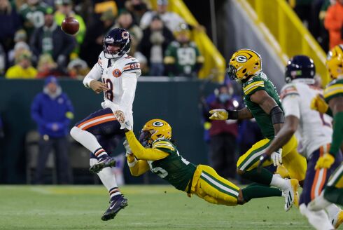 Bears quarterback Caleb Williams breaks the tackle of Green Bay Packers cornerback Keisean Nixon on Sunday, Dec. 7, 2025, in Green Bay, Wisconsin.