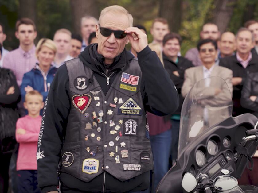The video in which Gov. Bruce Rauner officially announces his re-election bid is narrated by the governor, who continues to slam House Speaker Michael Madigan accompanied by footage the leather-clad Republican riding his Harley Davidson through Illinois.