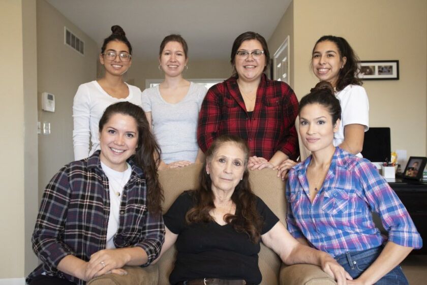 Elodia Esquinca (center) sits with a few of her granddaughters: Isabella Ospina, Adilene Esquinca, Evelyn Sandoval and Carolina Ospina (top left to right), Mariana Aldaba (bottom left) and Griselda Valadez (bottom right) in Aurora on Dec. 16, 2018. | Coli