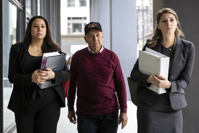 Peter Andrews, a co-defendant of former Ald. Edward Burke (14th), walks with attorneys into the Dirksen Federal Courthouse earlier this month.