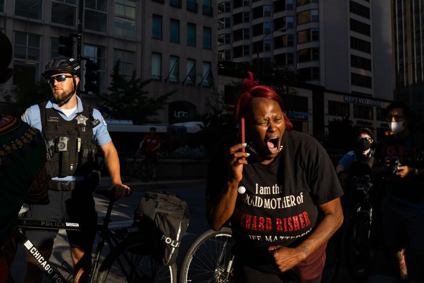 Lisa Simpson, the mother of Richard Risher, who was fatally shot by Los Angeles police in 2016, chants during a Black Lives Matter protest on the Magnificent Mile, Saturday evening, Aug. 29, 2020.