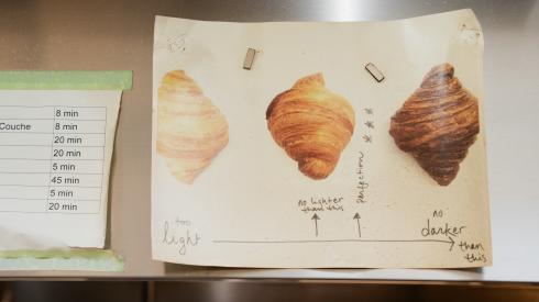 A poster that shows how brown a croissant should look after baking is displayed in the kitchen of Floriole Cafe and Bakery in Lincoln Park, Tuesday, Oct. 13, 2026.