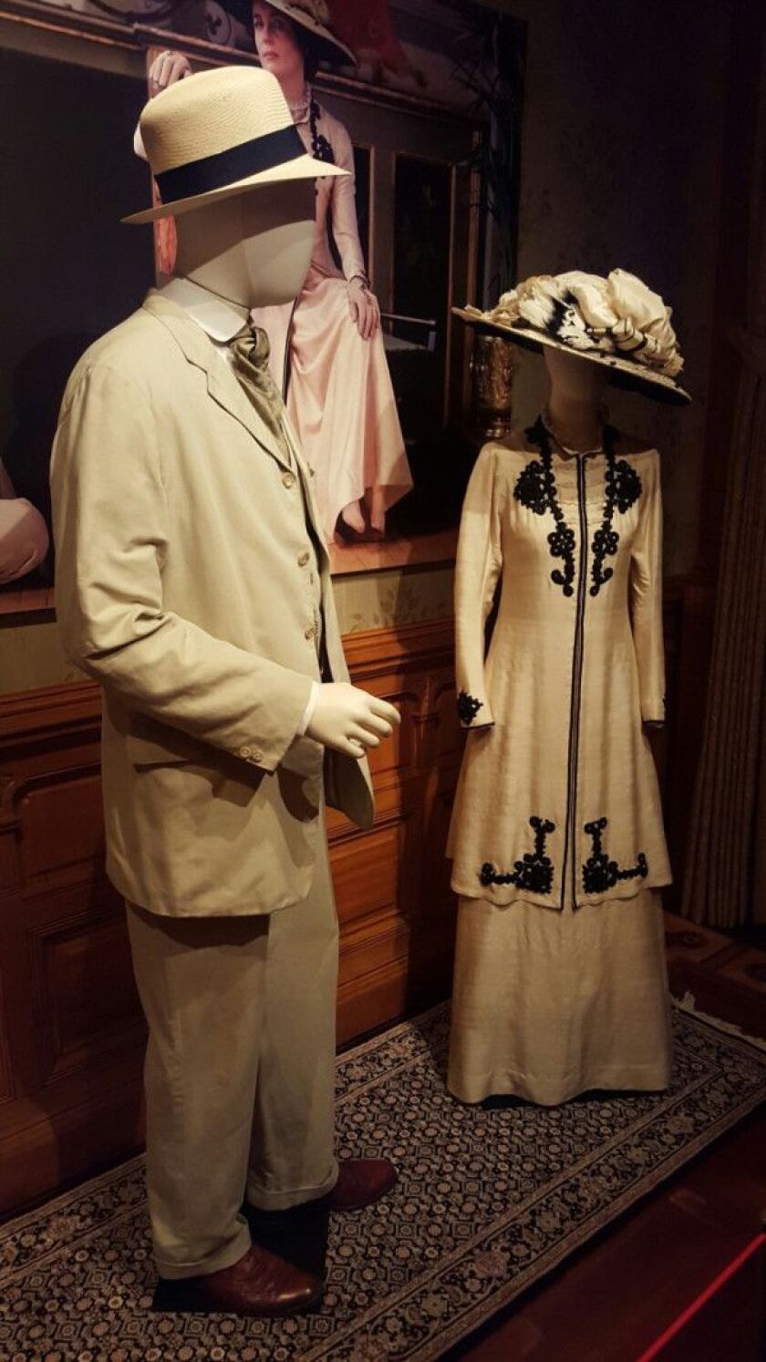 Downton Abbey (Masterpiece/PBS) Season 1. LEFT: Hugh Bonneville as Robert Crawley, Earl of Grantham; light cream linen suit and hat, watch fob, white shirt, collar, ascot with stock pin, brown shoes, socks and straw hat. RIGHT: Elizabeth McGovern as Cora
