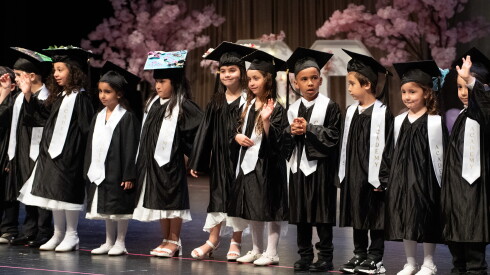 Kindergarten graduates take the stage during the Quran Blossoms end of year ceremony.