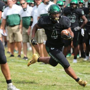 Glenbard West’s Joey Richmond (4) rounds the corner and heads up field for a big gain.