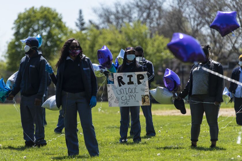 Postal workers from around the city gather at Kilbourn Park for a memorial for Unique Clay.