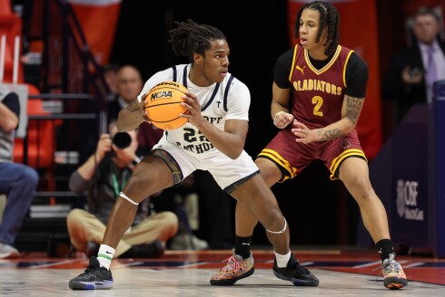 Althoff's Dierre Hill, Jr., (22) controls the ball as Christ the King's Christian Buford (2) defends during the Class 2A state semifinals.