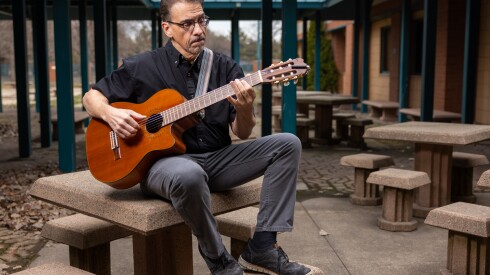Juan Díes, co-founder of the Sones de Mexico Ensemble, poses for a portrait on Saturday, March 21, 2026 outside the Arturo Velasquez Westside Technical Institute, where he teaches guitar.
