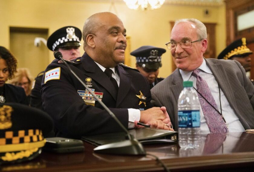 Chicago Police Supt. Eddie Johnson shakes hands with Rep. Daniel J. Burke, D-Chicago, after new gun legislation, part of which is written and named in honor of slain 18th District Cmdr. Paul Bauer, passed a committee on Tuesday in Springfield. | Ted Schur