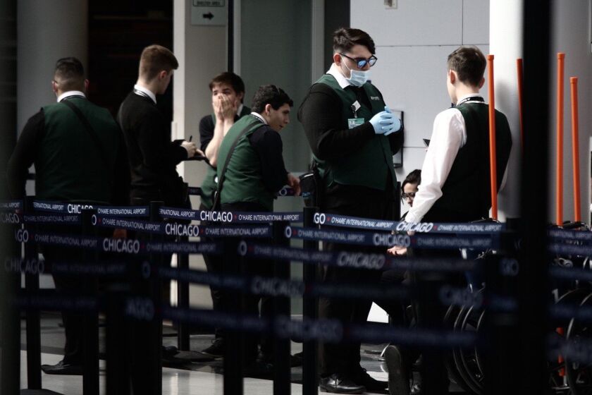 With air travel curtailed, the security lines for outbound passengers were short Sunday at O’Hare Airport.