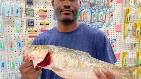 Travis Strickland smiles after weighing his pending Illinois-record skipjack herring at Henry’s Sports and Bait.
