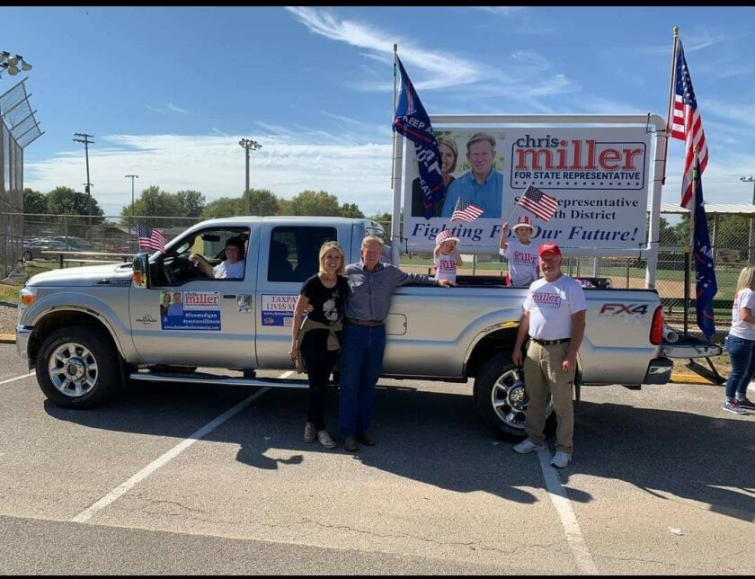 U.S. Rep Mary Miller and her husband, state Rep. Chris Miller, center, pose next to their pick-up truck in a campaign photo.