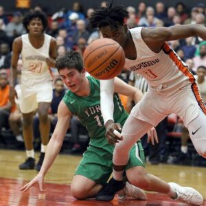 York’s John Milling (11) and Whitney Young’s Sangolay Njie (1) chase after the loose ball in Hillside, Wednesday, March 6, 2019. | Kevin Tanaka/For the Sun Times