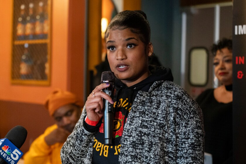 Julia Bradley of Black Youth Project 100 speaks during a gathering at Carnitas Uruapan in Little Village, where Black organizers expressed their support for immigrants and encouraged Black and Latino communities to stand together, Saturday, Dec. 6, 2025.