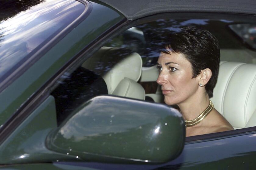 British socialite Ghislaine Maxwell, driven by Britain’s Prince Andrew, leaves the wedding of a former girlfriend of the prince, Aurelia Cecil, at the Parish Church of St Michael in Compton Chamberlayne near Salisbury, England, in 2000.