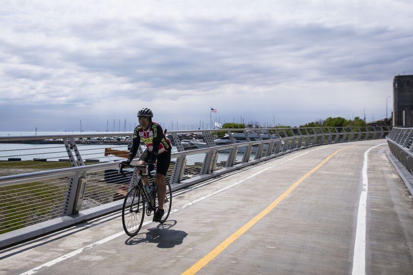 A bicyclist rides on the Navy Pier Flyover near the newly-completed part of the path that tracks the Lake Shore Drive Bridge over the mouth of the Chicago River, Monday morning, May 10, 2020.