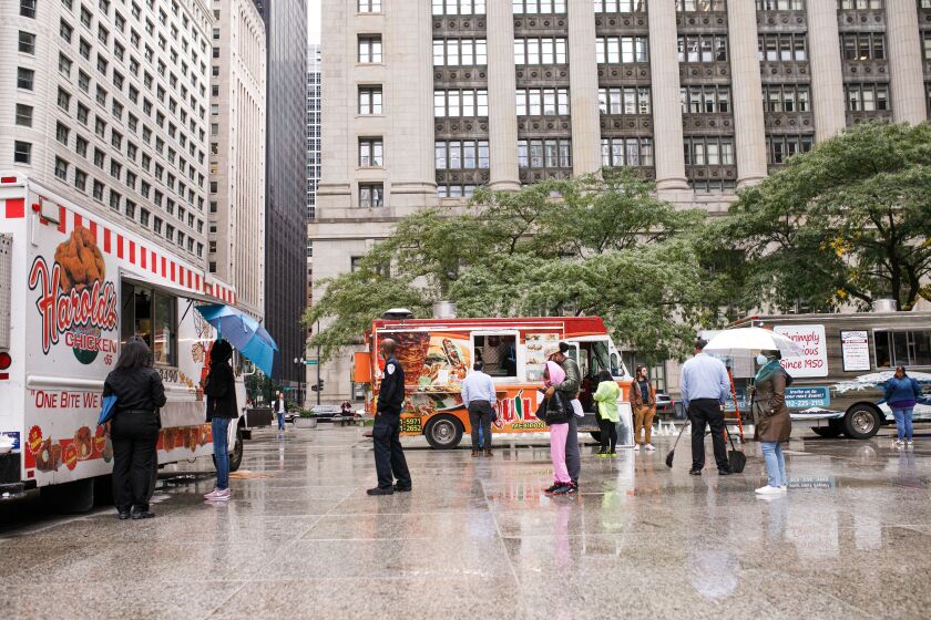 Chicagoans were prepared to brave the rain for some Harold’s Chicken. In addition to a food truck, the chicken restaurant has multiple locations on the South Side. Customers wait in like for the food trucks at Daley Plaza, Friday afternoon, Oct. 15, 2021