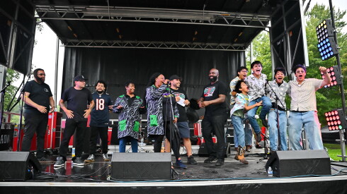 Members of the band Large Mouth celebrate on stage after being announced as the winners of the Community Talent Showcase.