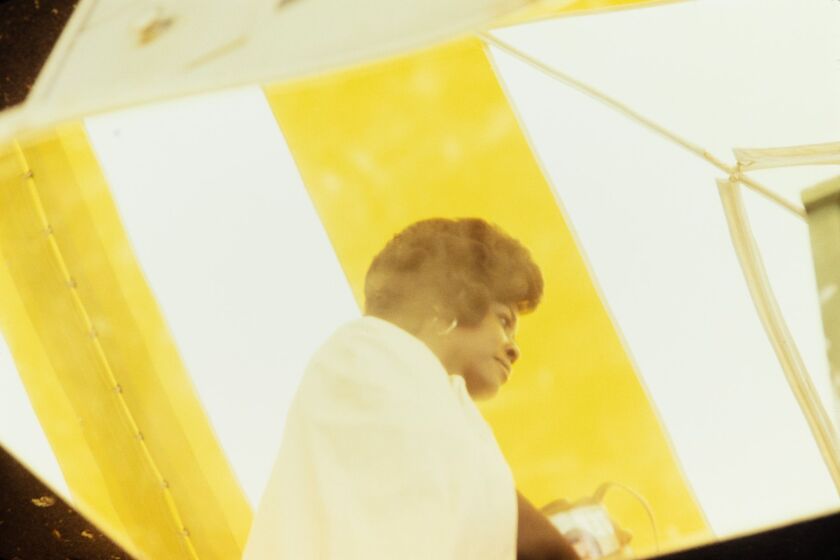 Vivian Maier, “Woman in a yellow and white tent,” likely Chicago suburbs, October 1974, Inkjet print.