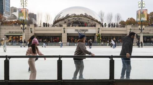 Groups of people slowly make their way around the McCormick Tribune Ice Rink holding onto the railing as dozens of other ice skate past ahead of the 112th Annual Tree Lighting Ceremony at Millennium Park, Friday, Nov. 21, 2025.