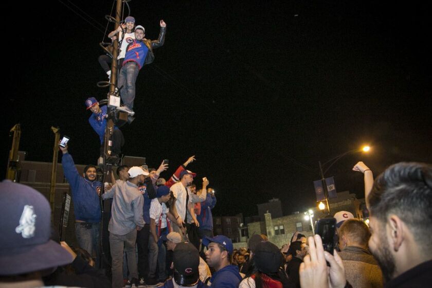 Cubs fans celebrate after the win Saturday sent the team to its first World Series since 1945. | Ashlee Rezin / Sun-Times