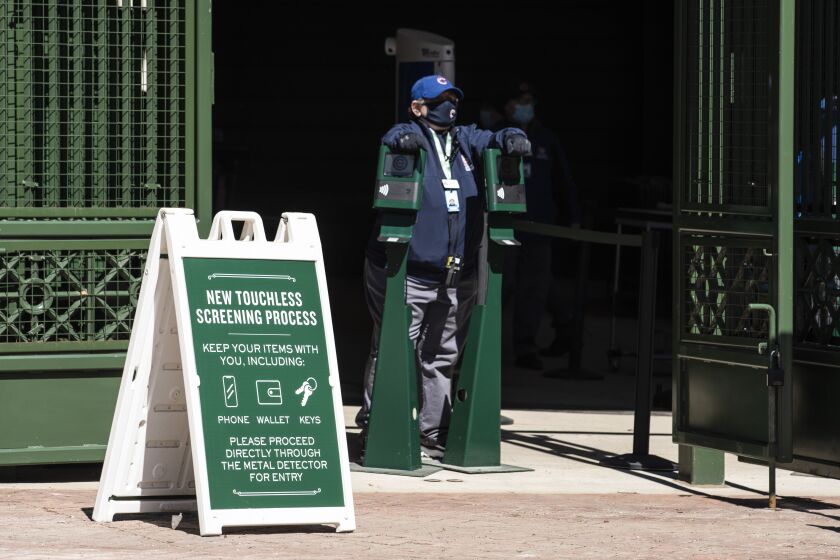 An usher waits for fans to enter Wrigley Field before the Chicago Cubs Opening Day game against the Pittsburgh Pirates.
