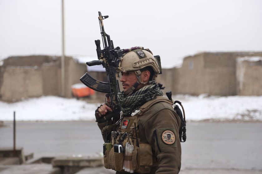 A member of Afghan security personnel arrives at the site of an attack at a military academy in Kabul, Afghanistan on Monday. | AP photo