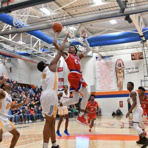 Curie’s Justin Harmon (24) makes an awkward shot, Saturday 12-29-18. Worsom Robinson/For Sun-Times
