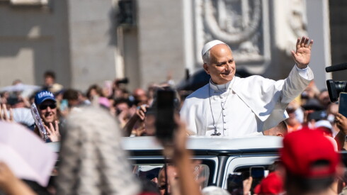 Pope Leo XIV greets the crowd awaiting him at his weekly general audience in Vatican City, Wednesday, May 27, 2026.