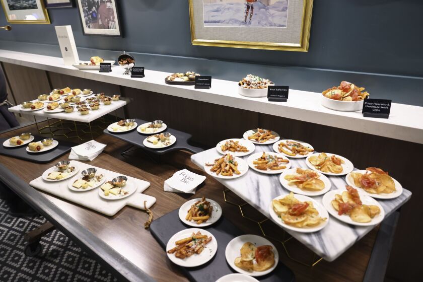 An array of plates with samplings of the food that will be served at the Blackhawks newly unveiled Rocky’s Bar in honor of Rocky Wirtz, former owner and chairman of the Blackhawks, at the United Center, Tuesday, Dec. 19, 2023.