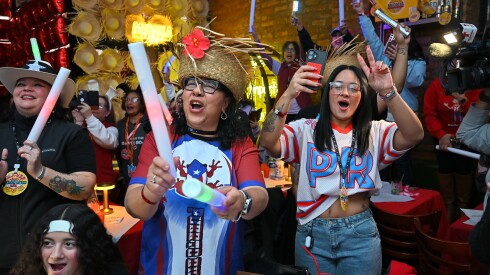 Football fans and Puerto Rican community members celebrate during the Benito Bowl Super Bowl halftime show watch party at the VIP Residencia Bar & Lounge in Humboldt Park on Sunday.
