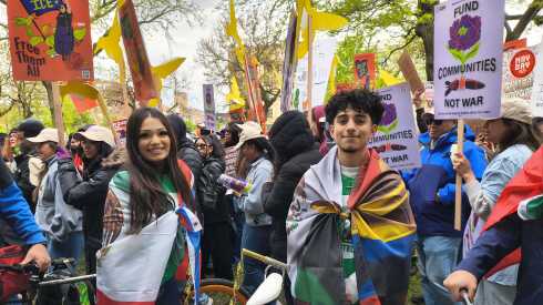 Two students draped in flags at the May Day rally in Chicago.