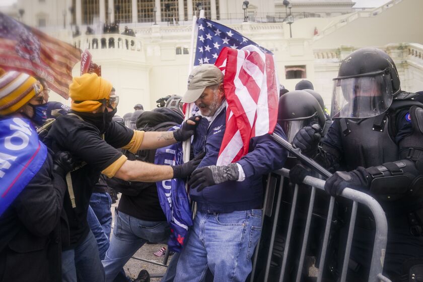 Supporters of President Donald Trump clash with the police before breaching the Capitol building on Jan. 6.
