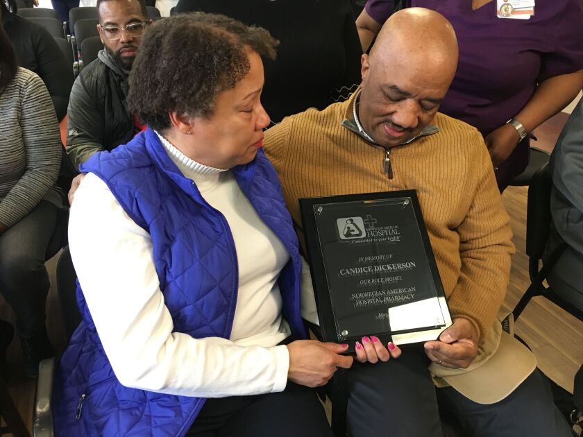 Candice Dickerson’s mother, Sandra Respress-Hambling, and stepfather, Dwight Hamblin, hold a commemorative plaque unveiled Tuesday at Norwegian American Hospital honoring their daughter. | Carlos Ballesteros/Sun-Times