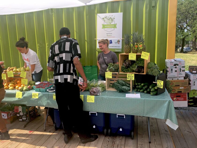 Resident Johnny Gordon browses different fruits at the Produce Box, which sells local produce from Green City Market’s Lincoln Park location and Hyde Park Produce. | Amanda Svachula/Sun-Times