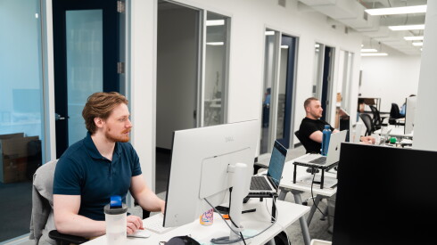 Yourco employees work from their desk at the company's Loop office.