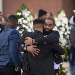 Two men embrace after the casket with the remains of Jemel Roberson is loaded into the hearse after his funeral, Saturday, Nov. 8, 2018, in Chicago. | Tyler LaRiviere/Sun-Times