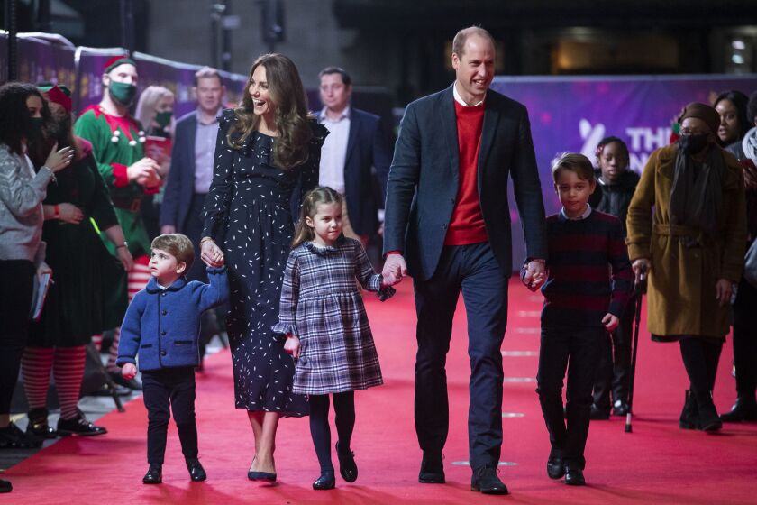 In this 2020 file photo, Britain’s Prince William and Kate, The Duke and Duchess of Cambridge and their children, Prince Louis, left, Princess Charlotte and Prince George arrive for a special pantomime performance at London’s Palladium Theatre.