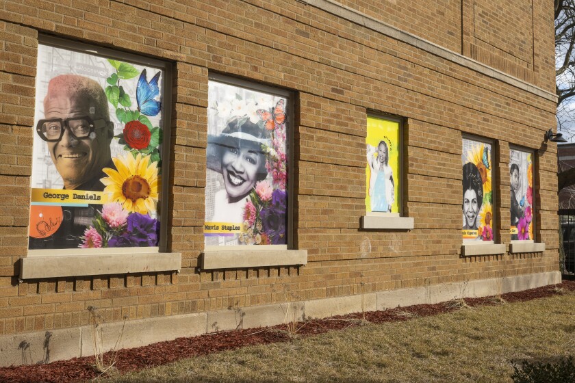 Five murals appear on the brick walls of the Lazarus Apartments in North Lawndale.