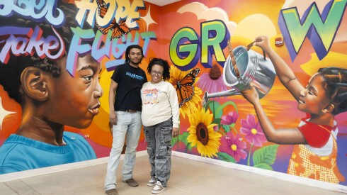 Keona Owens, founder and executive director of Touch Gift Foundation, with her son Jeremiah Owens, director of Lov’N Streetz, in front of a mural in the foundation's Chatham building.