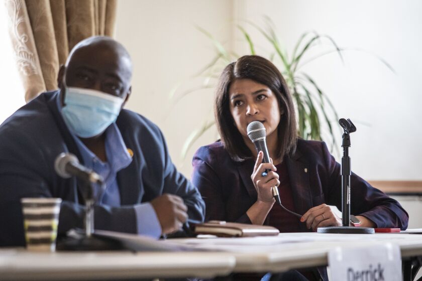 Ald. Derrick Curtis (18th) looks on as Ald. Silvana Tabares (23rd) asks a question during a Southwest Side meeting Sunday to choose who will take over Madigan’s House seat.