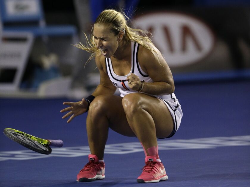 Dominika Cibulkova of Slovakia celebrates after defeating Victoria Azarenka of Belarus in their fourth round match at the Australian Open tennis championship in Melbourne, Australia, Monday, Jan. 26, 2015. (AP Photo/Lee Jin-man)