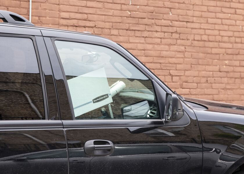 A federal agent drives away with boxes of records seized from the Far South Side ward office of Ald. Carrie Austin. (34th)