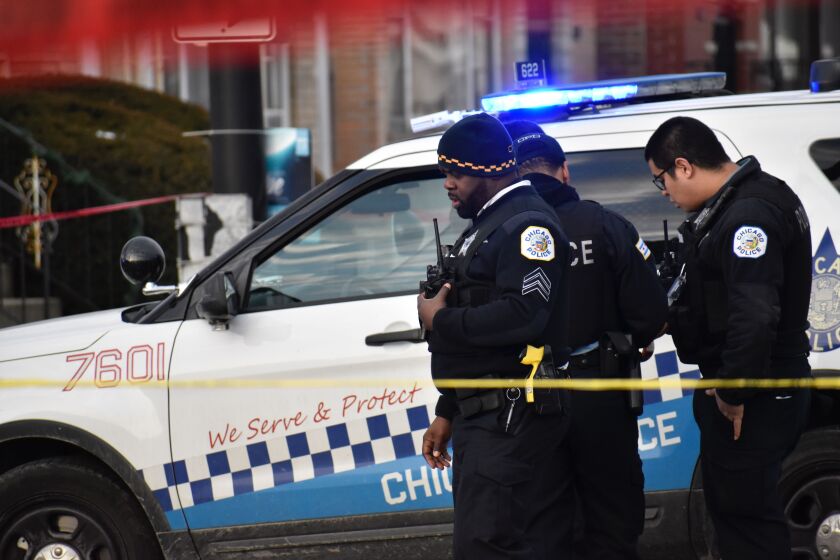 Chicago police investigate a scene where a man and woman was shot to death March 1, 2020, in Chatham.