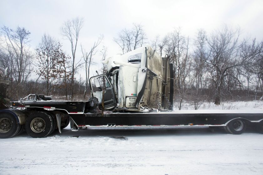 <small><strong>Road crews work to clear wrecked vehicles and debris along Interstate 94, Saturday, Jan. 10, 0215, the day after a series of crashes closed the highway between mile markers 88 and 92 in eastern Kalamazoo County, near Galesburg, Mich. | Chri